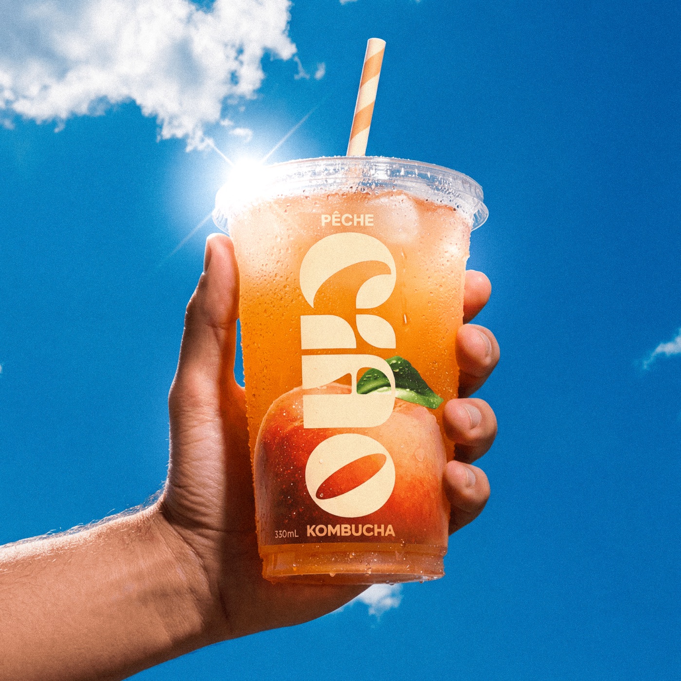 Ciao Kombucha — orange cup against blue sky